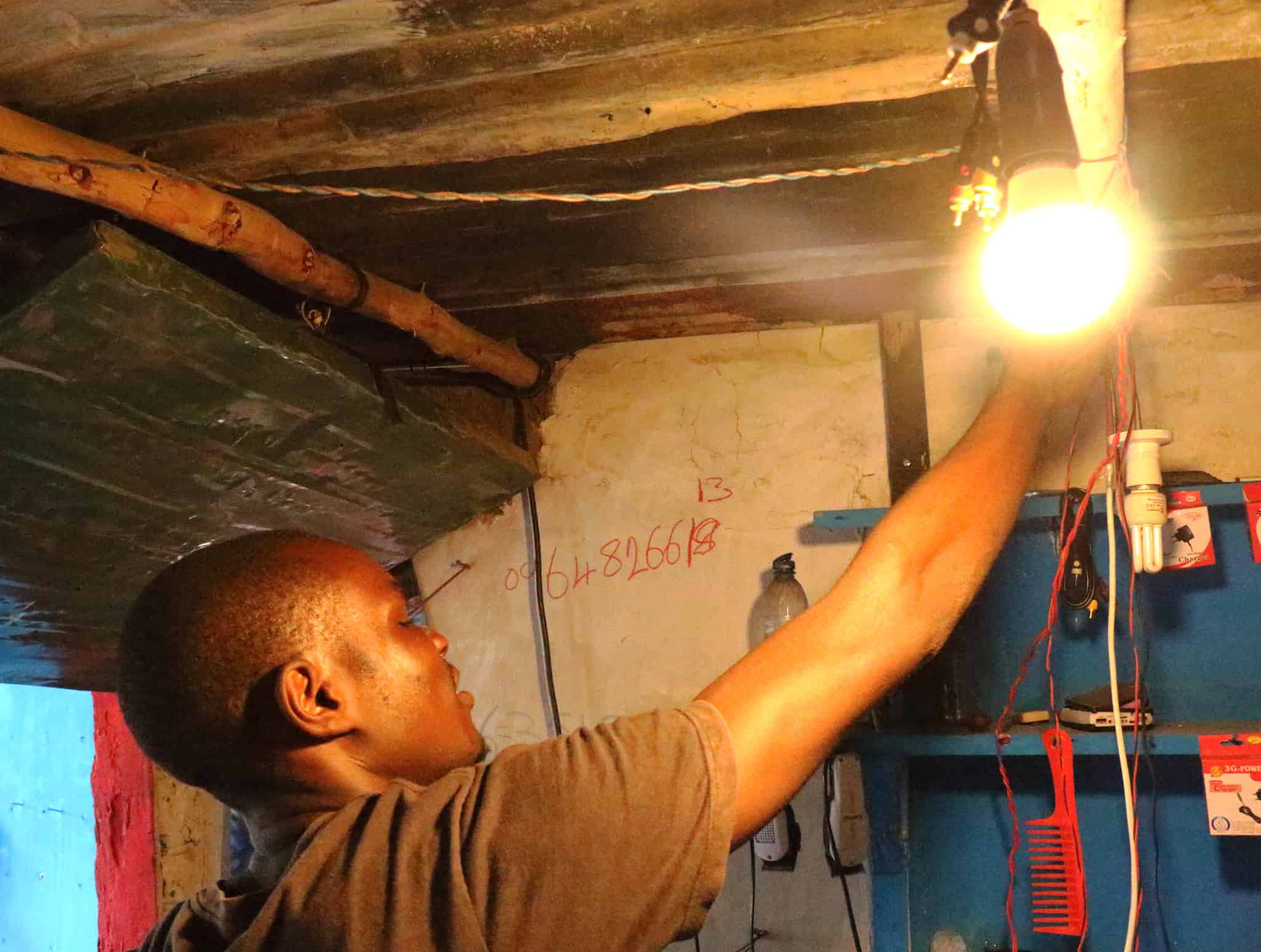 A man adjusts a lightbulb