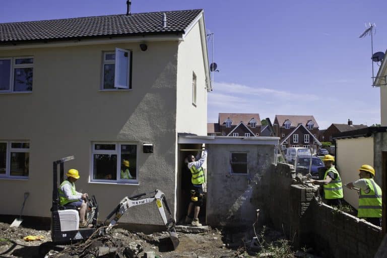 Builders work on a house