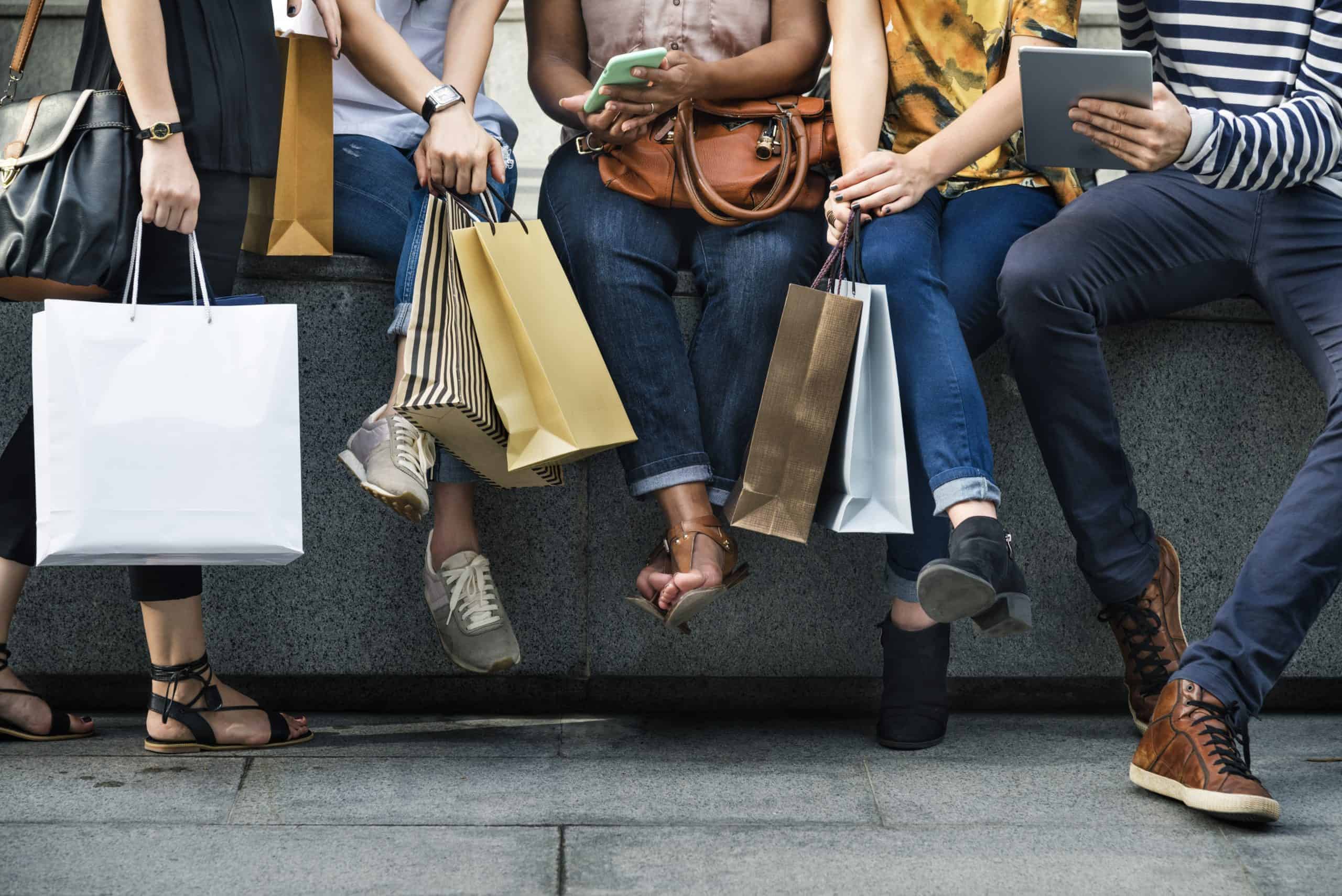 A group of people holding shopping bags