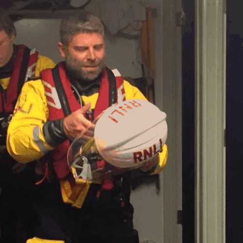 Ashden team member, Giles Bristow in a RNLI life jacket and holding a helmet