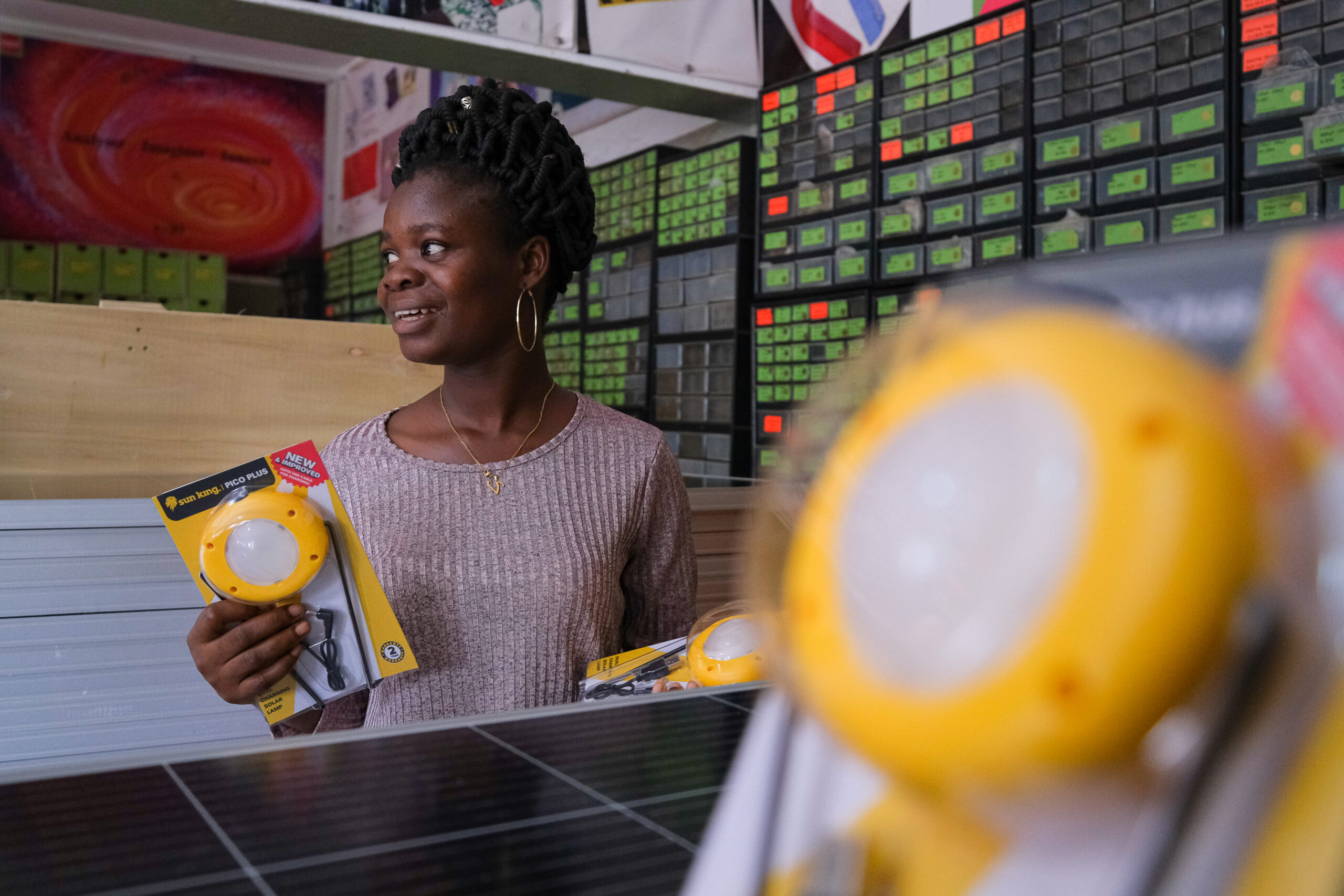 Woman holds solar powered lamp products