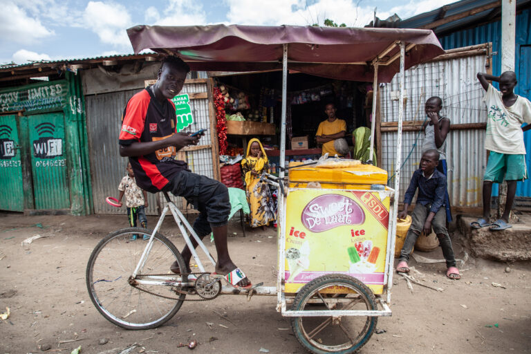 A man riding a bike and selling ice cream in Kakuma Ventures refugee camps