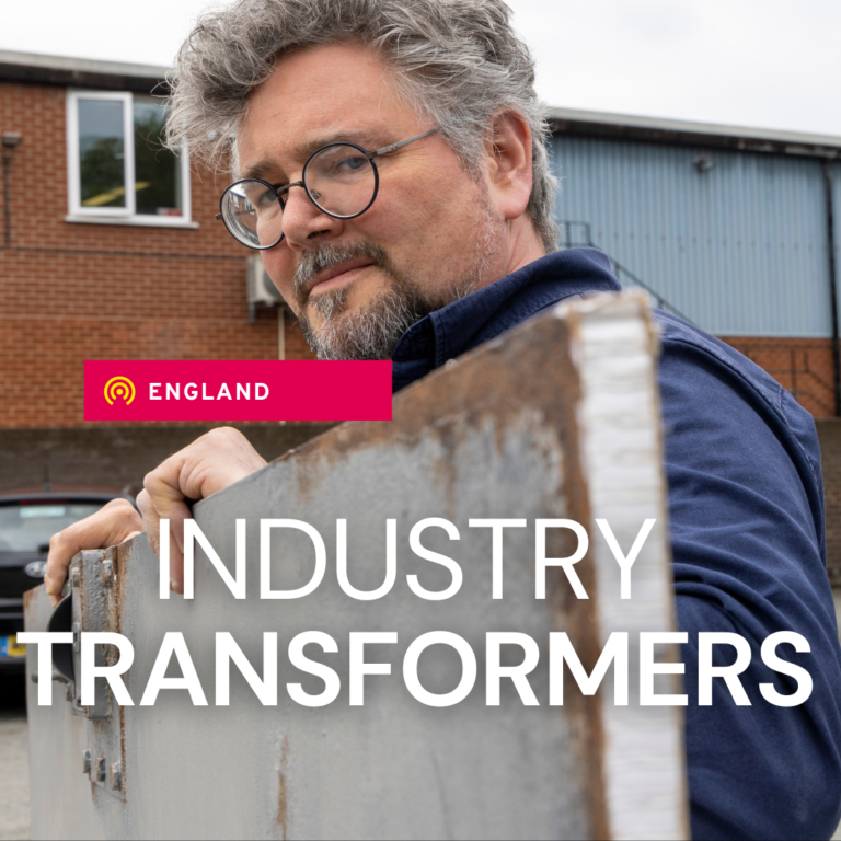 Asset with a male carrying a cardboard film set with text stating 'Industry Transformers'