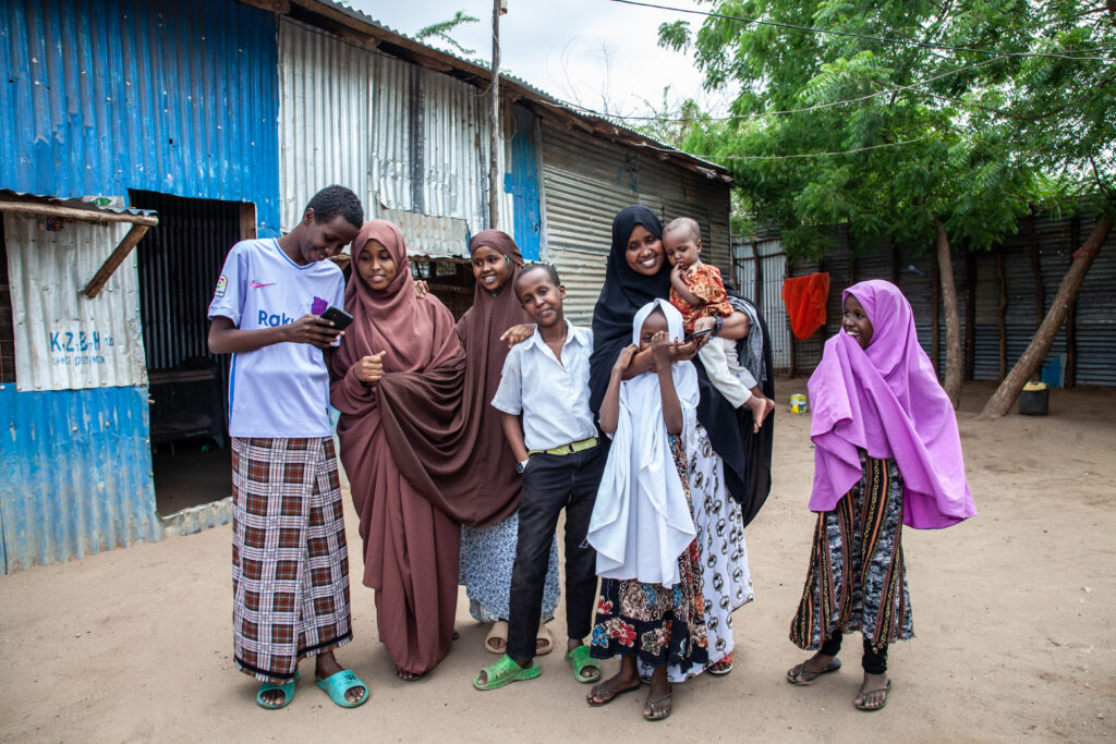 A photo of Hawa Mohamed and her family outside their home. Kakuma refugee camp,
