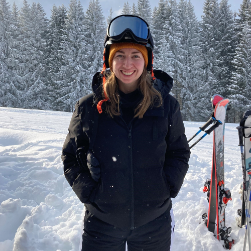 Ashden team member, Alison Lasenby wearing a ski helmet and black ski clothing on a ski slope.
