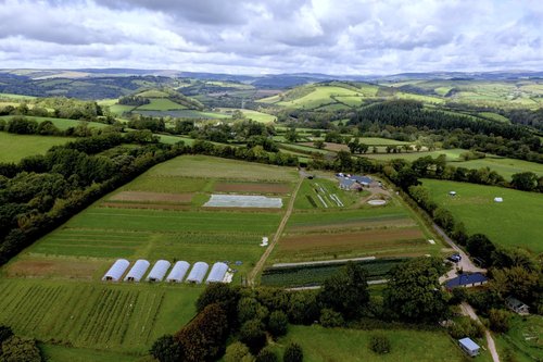 A landscape aerial picture of the Apricot farm farm with barns