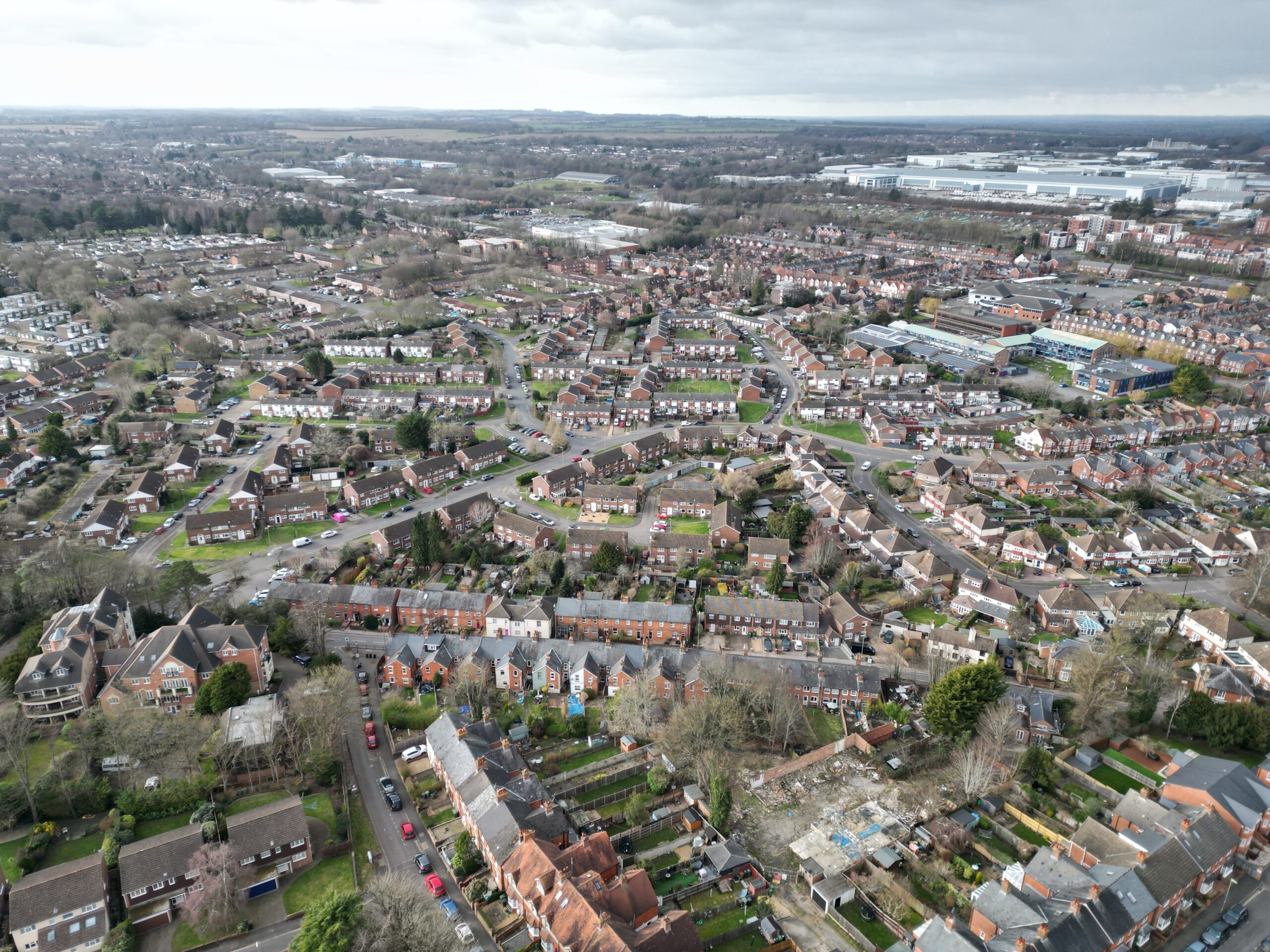 Aerial view of a community consisting of brick buildings and trees